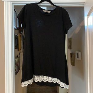 Short sleeved black dress with lace trim.
